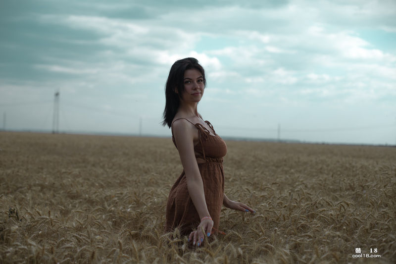 Beautiful teen Lyalya massages her breathtaking big tits in a wheat field